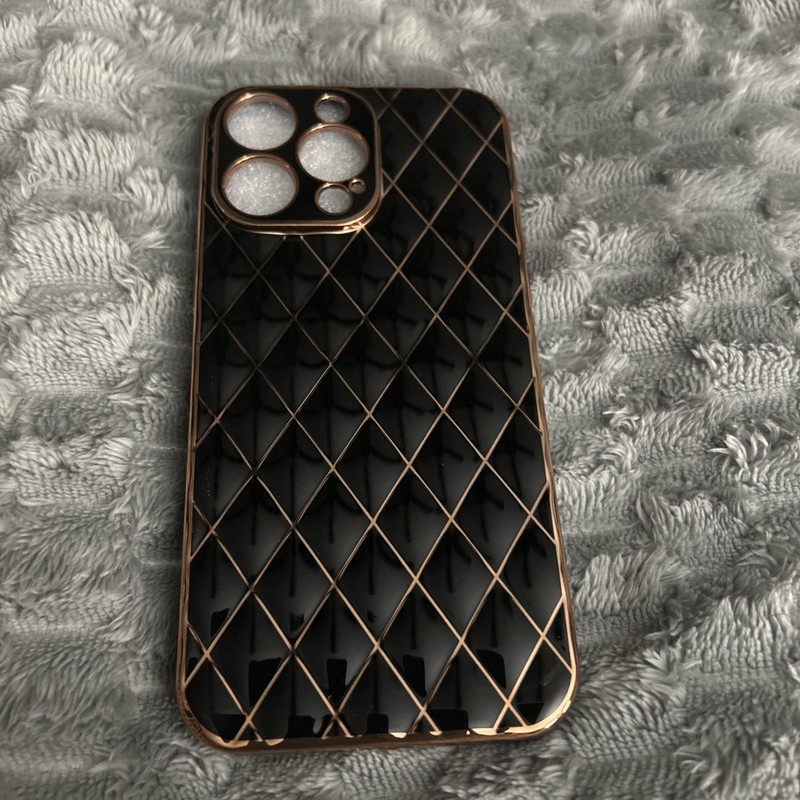 iPhone 14 Pro Max. Black with Gold Trim and Design.